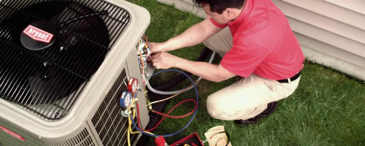 HVAC technician servicing an outdoor air conditioner unit in Fort Collins, CO